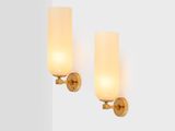 pair of brass sconces with frosted glass shades