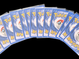 six packs of pokemon cards sitting on top of each other