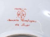 an image of a plate with a red writing on it