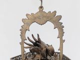 a bronze statue of a bird in a basket