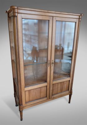 an image of a wooden display cabinet with glass doors
