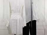 a white shirt and black pants on a mannequin stand