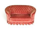 an image of a red couch with ruffles on it