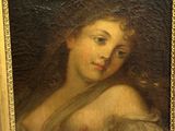 painting of a woman in a gold frame with a black background