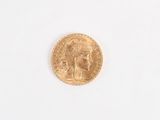 a gold coin with a picture of a woman on it