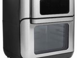 une friteuse à air chaud argentée et noire posée sur un plan de travail blanc