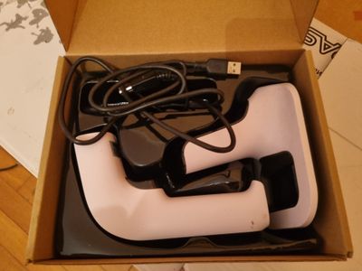 a box with a pair of black and white shoes in it