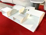 a model of a house sitting on a red carpet