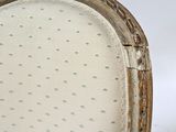 a close up of the back of a chair with holes in it