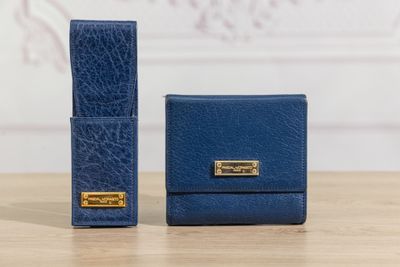 deux portefeuilles en cuir bleu posés sur une table en bois