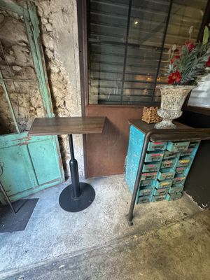a small table and a small cabinet in the corner of a room
