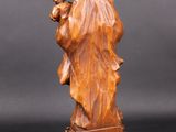 a wooden statue of a man holding a child in his arms