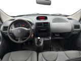 the interior of a small car with a steering wheel and dashboard