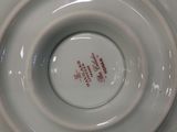a close up of a white plate with a red design on it