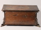 an old wooden chest sitting on top of a white surface