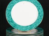 five plates stacked on top of each other on a black background