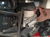 a pile of old cameras and other electronics on a table