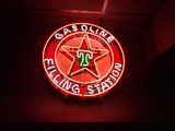 neon sign of a gas station with a star on it
