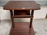 a small wooden table with a shelf on top of it