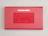 the back of a red electronic device with a white background