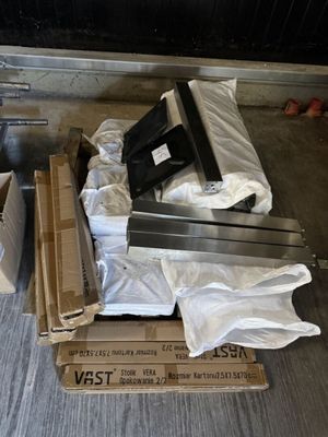 a pile of laptops sitting on the floor next to some boxes