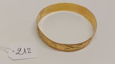 gros plan d'un bracelet en or portant une étiquette de prix