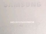 the back of a white samsung phone with the samsung logo on it
