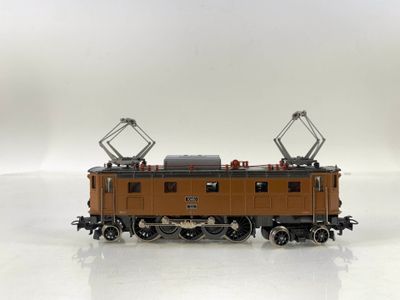 a toy train on a white surface with a white background