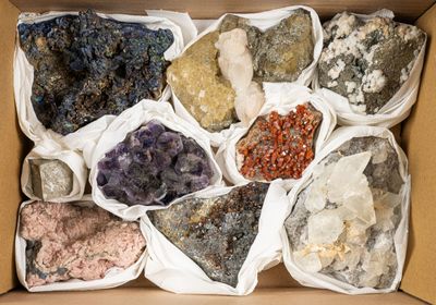 a box full of different colored rocks in it