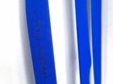 three blue toothbrushes that are on a white surface
