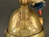 an old helmet with a feather on top of it on a stand