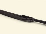 a black knife with a black handle on a white surface