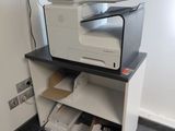 a printer sitting on top of a shelf in a room