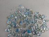 a pile of blue and white glass beads on a table