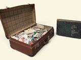 two suitcases with money inside of them on a white surface
