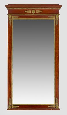 a large antique mirror with a wooden frame and gold trimmings