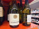 several bottles of wine are on a shelf in a store