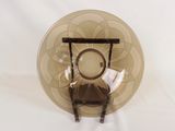 a glass plate with a chair on it on a table
