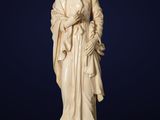 a carved ivory figurine of a man holding a child