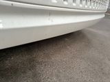 a white car that is parked on the side of the road