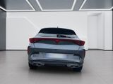 the rear end of a silver car in a white room