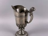 a silver cup that is sitting on a table