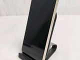 a cell phone that is on a stand on a table