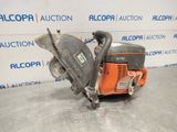 a close up of a chainsaw on a table in front of a wall