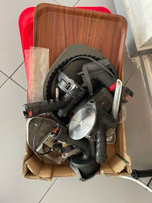 a box of tools sitting on the floor next to a sink