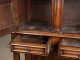 an old wooden cabinet with two drawers on it