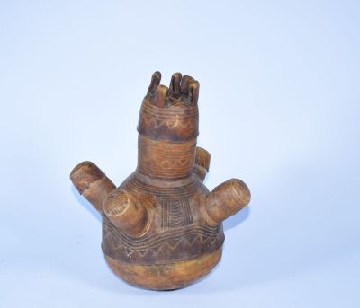 un vase marron orné d'une main, sur un fond blanc