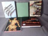 three books on a table with a gun and a gun on the cover