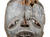 an old wooden mask on a white background with a white background