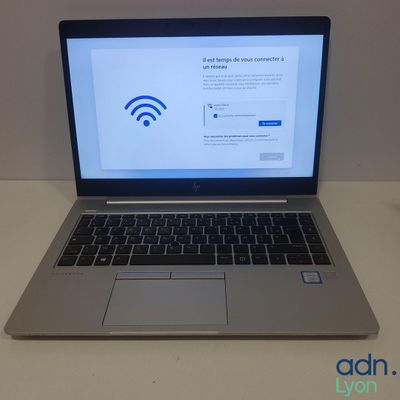 an open laptop computer sitting on top of a desk next to a mouse